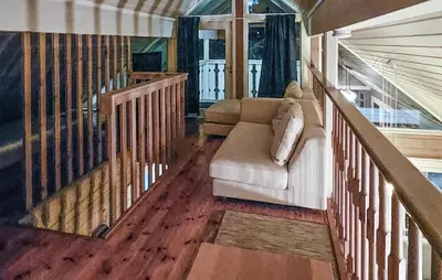 a living room with a couch and a staircase at Gorgeous Home In Uvdal With Wifi in Uvdal
