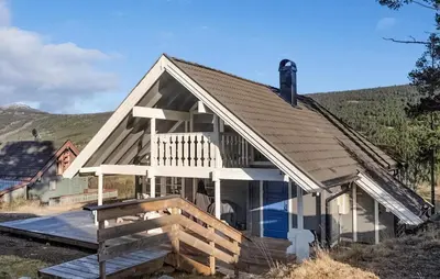 a large house with a porch and a deck at Gorgeous Home In Uvdal With Wifi in Uvdal