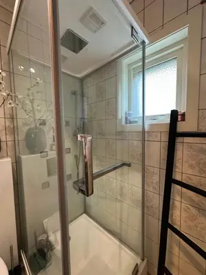 a shower with a glass door in a bathroom at Leilighet med nydelig utsikt over Bergen in Bergen