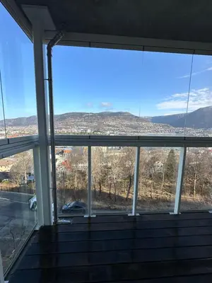 a view from the inside of a building with windows at Leilighet med nydelig utsikt over Bergen in Bergen