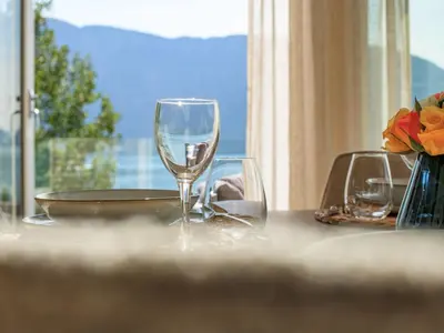 a table with two wine glasses on a table with a window at Holiday Home Hildebu by Interhome in Sørbø