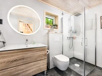 a bathroom with a shower and a toilet and a sink at Holiday Home Hildebu by Interhome in Sørbø