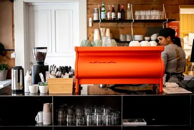 a person behind a counter in a kitchen at Bed and Brunsj, Sand in Sand