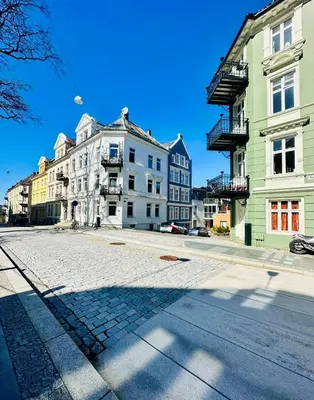 an empty street in a city with buildings at Sparresgaten 2 in Bergen