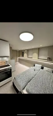 a large room with two beds and a kitchen at Sparresgaten 2 in Bergen