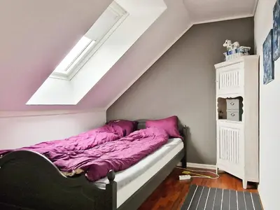 a bedroom with a bed with purple sheets at 8 person holiday home in Masfjordnes-By Traum in Masfjorden