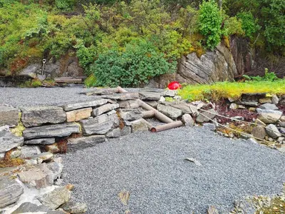 a stone wall with a red ball on top of it at 8 person holiday home in Masfjordnes-By Traum in Masfjorden