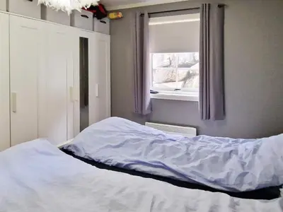 a bed in a room with a window at 8 person holiday home in Masfjordnes-By Traum in Masfjorden