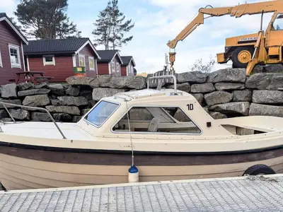 a small boat is being lifted by a crane at 3 person holiday home in Flatraket-By Traum in Barmen