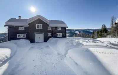 a house covered in snow with a lot of snow at Gorgeous Home In Svatsum With Wifi in Svingvoll