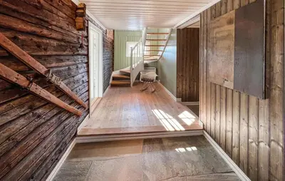 a hallway with wooden walls and stairs in a house at Gorgeous Home In Svatsum With Wifi in Svingvoll