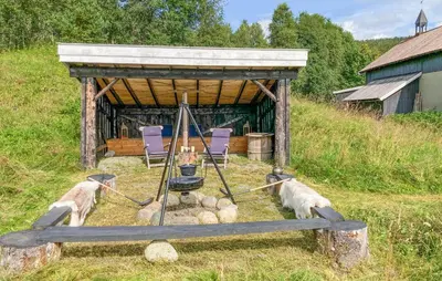 a gazebo with three sheep standing in the grass at Gorgeous Home In Svatsum With Wifi in Svingvoll