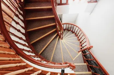 a wooden spiral staircase in a room with baseball bats at The View - BIG Apartment in City Center in Bergen