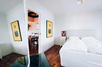 a bedroom with a white bed and a table at The View - BIG Apartment in City Center in Bergen