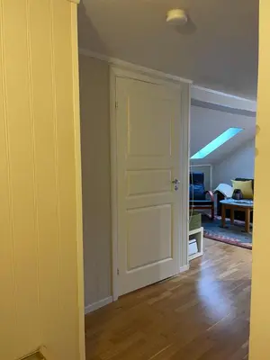 a room with a door and a living room at Bakkebo Rampestreken in Åndalsnes