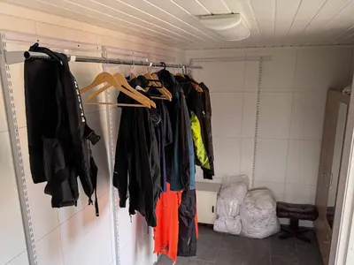 a closet with clothes hanging on a rack at 8 person holiday home in Flatraket-By Traum in Barmen