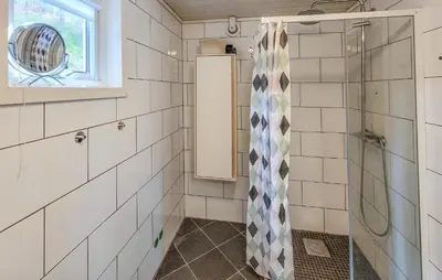 a bathroom with a shower and a window at Nice Home In Jelsa With Kitchen in Jelsa