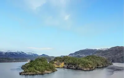 an island in the water with mountains in the background at Nice Home In Jelsa With Kitchen in Jelsa
