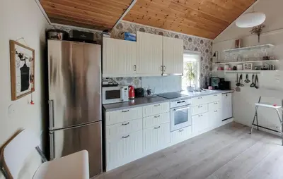 a kitchen with white cabinets and a stainless steel refrigerator at Nice Home In Jelsa With Kitchen in Jelsa