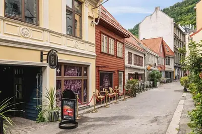 an empty street in a town with buildings at Dinbnb Apartments I Family Dream in Bergen I Playroom I Private Garden in Bergen