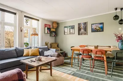 a living room with a couch and a table at Dinbnb Apartments I Family Dream in Bergen I Playroom I Private Garden in Bergen