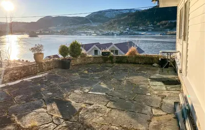 a stone patio with a view of a body of water at 4 Bedroom Awesome Home In Nedre Vats in Stokka