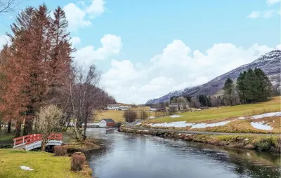 a river in a field with snow on the ground at 4 Bedroom Awesome Home In Nedre Vats in Stokka