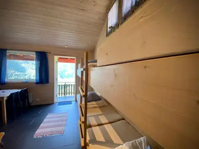 a small room with a bunk bed and a staircase at Hole Hytter in Geiranger