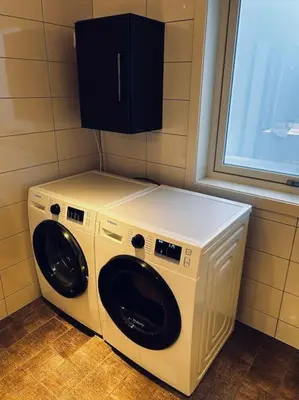 a washer and dryer in a room with a window at Moderne rekkehus, god standard. in Ålesund