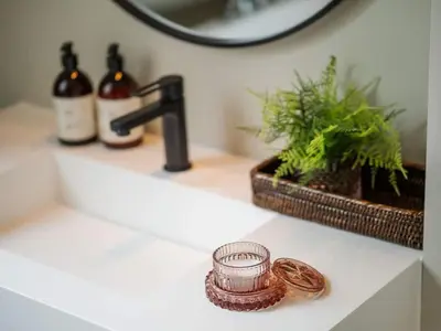 a bathroom sink with a candle on a counter at Vertshuset Konow in Bergen
