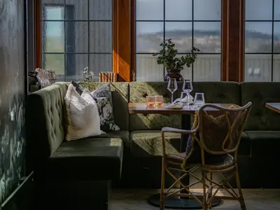 a living room with a green couch and a table at Vertshuset Konow in Bergen