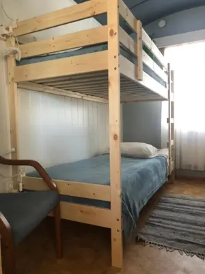a bunk bed in a room with a wooden bunk bed at Rena Hostel in Rena