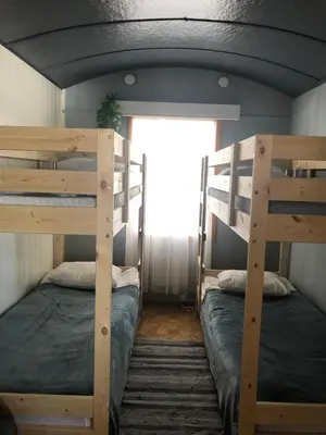 two bunk beds in a room with a window at Rena Hostel in Rena