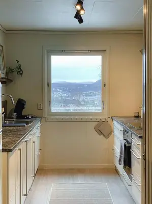 a kitchen with a large window and a sink at Spacious villa with view - 5BR - FREE parking - Great Wi-Fi in Bergen