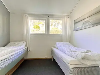 two beds in a room with two windows at 6 person holiday home in Dalsøyra-By Traum in Dalsøyra