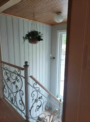 a room with a staircase with a plant on the ceiling at Sveciu namai in Vikedal