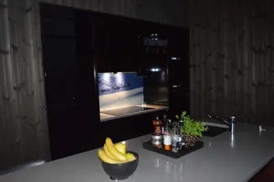 a kitchen with bananas on a counter with a television at Pow Panorama - High standard Mountain home in Sogndal