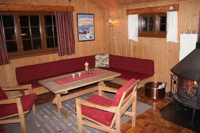 a living room with a couch and a table and a fireplace at Trevet by Norgesbooking - cabin close to skicenter in Ål