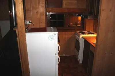 a kitchen with a white refrigerator and a stove at Trevet by Norgesbooking - cabin close to skicenter in Ål