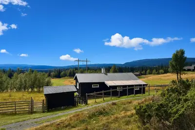 a barn on a hill in a field at Einkjerrbu cabin by Norgesbooking - in Svingvoll