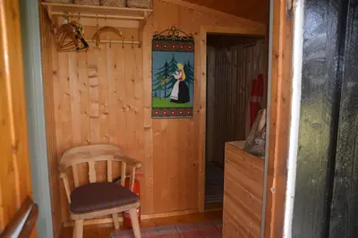 a room with a chair and a picture on the wall at Einkjerrbu cabin by Norgesbooking - in Svingvoll
