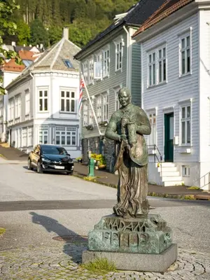 a statue of a man standing on a street at Modern Penthouse in Sandviken in Bergen