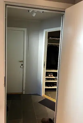 a walk in closet with a door and a pantry at Modern Penthouse in Sandviken in Bergen
