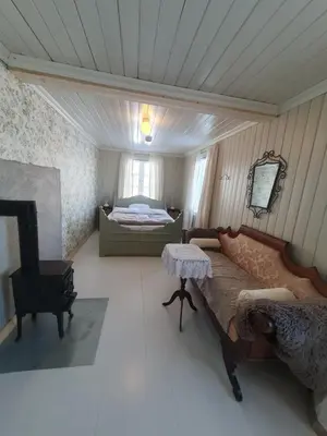 a bedroom with a bed and a table in it at Fagerstrand, storhytte ved Bygdin i Jotunheimen in Beitostøl