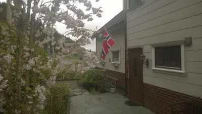 a house with a flag on the side of it at Sveciu namai in Sandeid