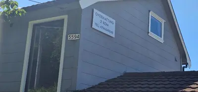 a house with a sign on the side of it at Sveciu namai in Sandeid