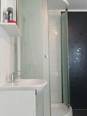 a bathroom with a sink and a shower at Sveciu namai in Sandeid