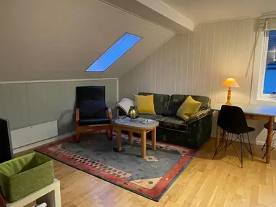 a living room with a couch and a table at Bakkebo Trollstigen in Åndalsnes