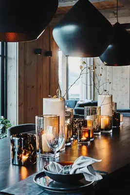 a wooden table with candles and lights on it at Chalet Strandafjellet in Stranda