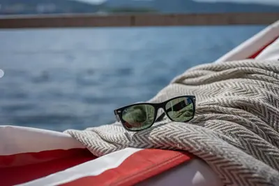 a pair of sunglasses sitting on top of a boat at New! Sea front apt. with terrace above the sea! in Bergen